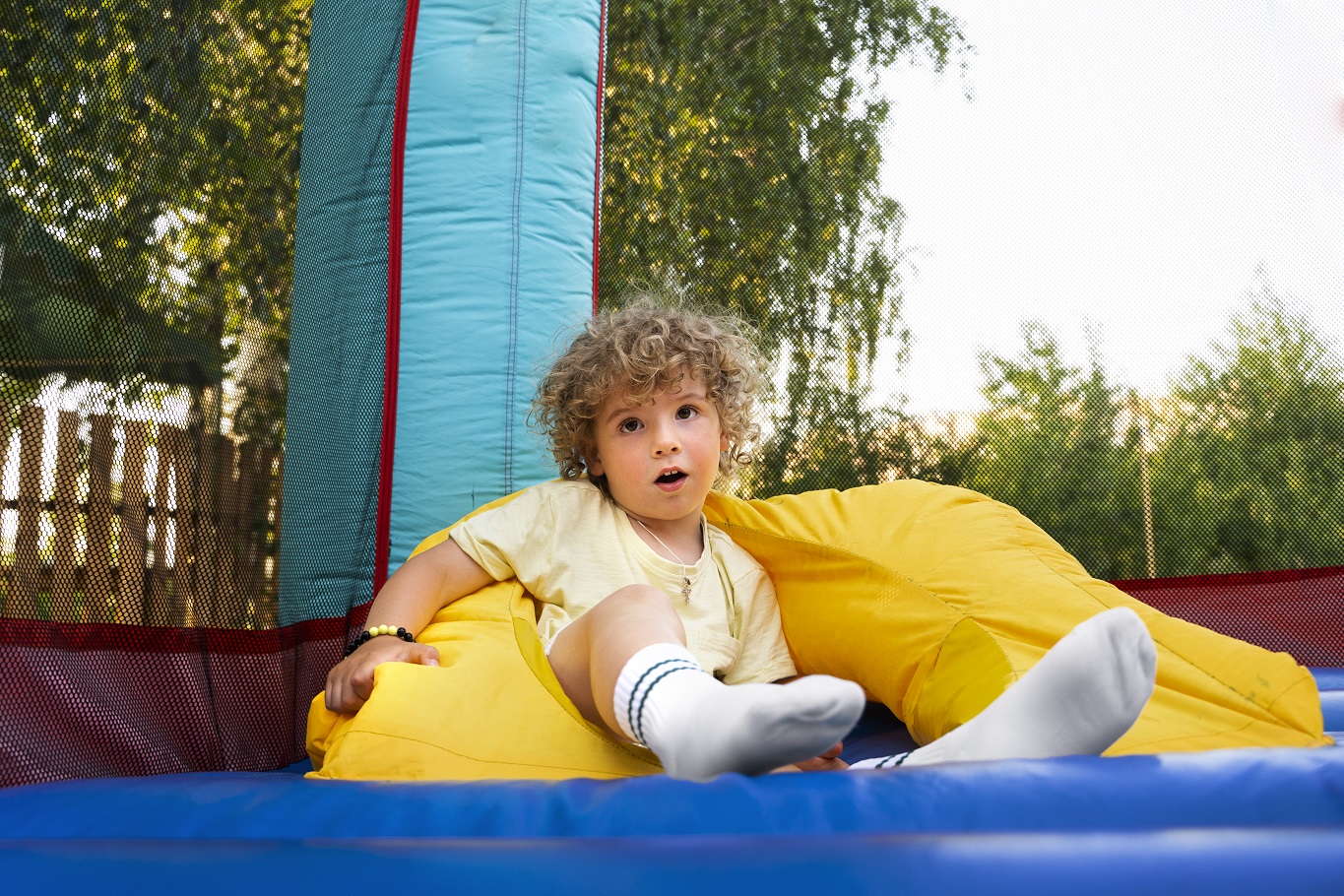 boy-laying-bounce-house-full-shot